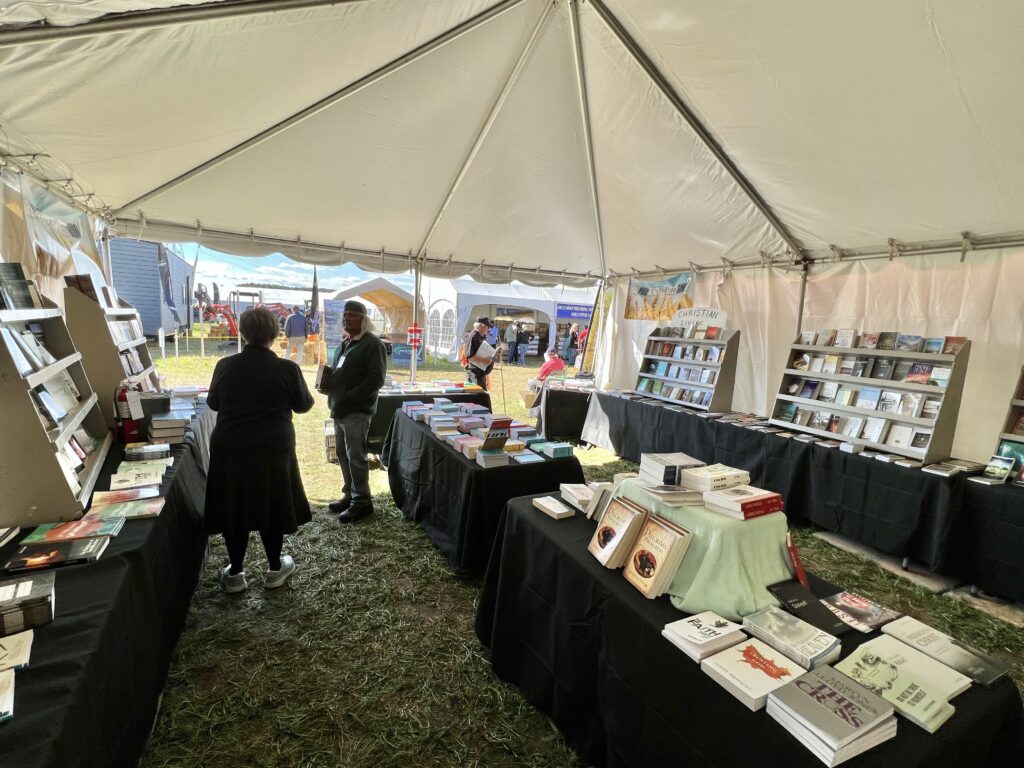 inside of tent with books on tables at international plowing match 2023